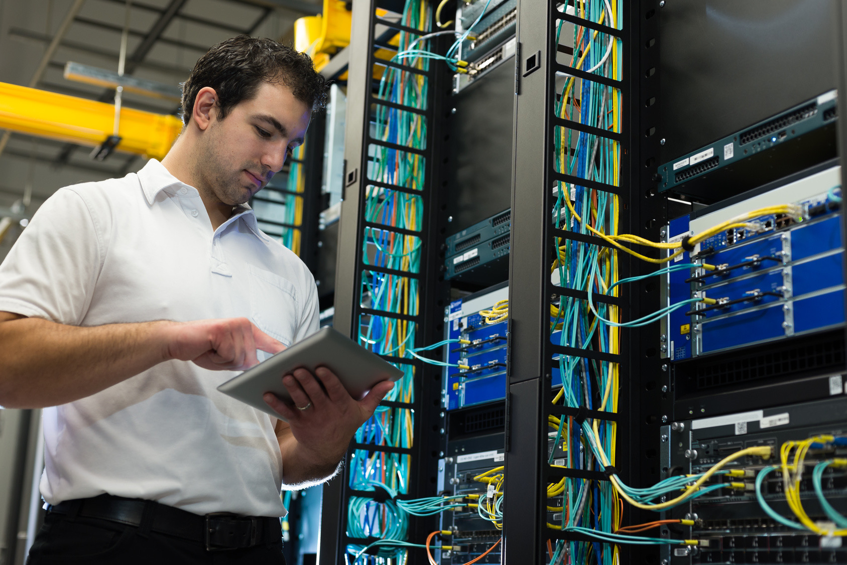 IT technician with network equipment and tablet